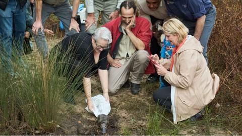 scientists with platypus