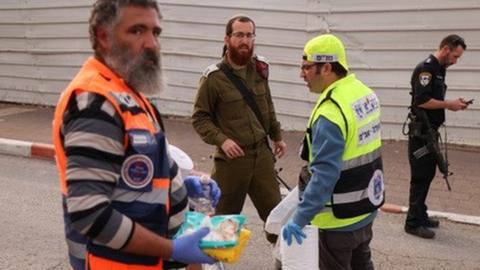 Israeli volunteers and security personnel at scene of Ariel attack (15/11/22)