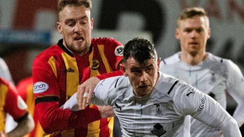 Partick Thistle's Kevin Holt and Inverness Caledonian Thistle's Aaron Dorans