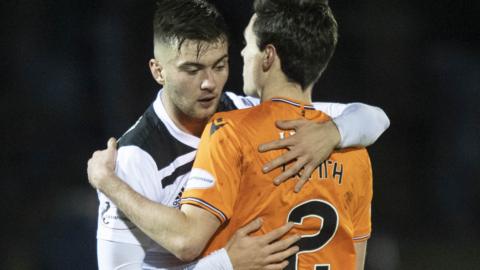 Ayr United's Daniel Harvie embraces Dundee United’s Liam Smith