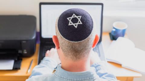 Jewish man using a laptop