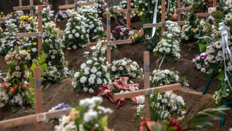 : Makeshift wooden crucifix's mark the graves of people killed in the Easter Sunday attack on St Sebastian's Church, on April 23, 2019 in Negombo, Sri Lanka. At least 359 people were killed and 500 people injured after coordinated attacks on churches and hotels on Easter Sunday which rocked three churches and three luxury hotels in and around Colombo as well as at Batticaloa in Sri Lanka