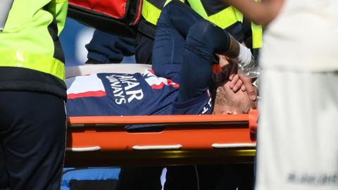 Neymar is carried off on a stretcher during PSG's match with Lille
