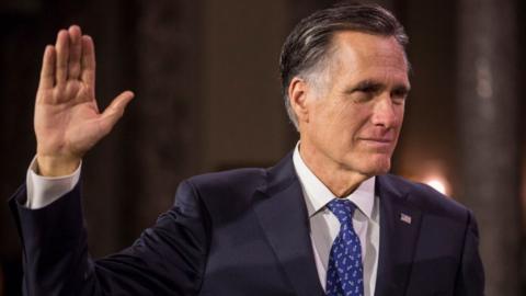 Mitt Romney raising his right hand