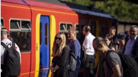 Commuters about to get on a train at vauxhall