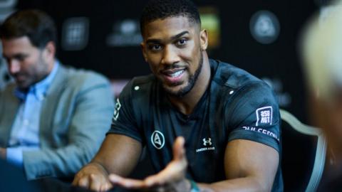 Anthony Joshua speaks to the media