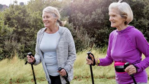 Stock image of two elderly women walking