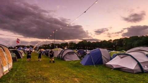 A number of tents installed in the campsite area