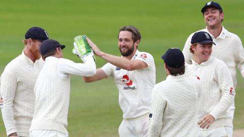 England celebrate a wicket by Chris Woakes