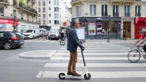 A man rides an electric scooter in Paris on 17 June 2019