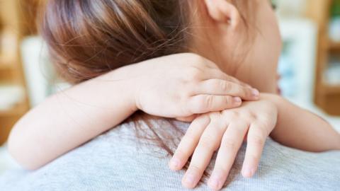 woman hugging child