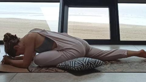 Millie Laws in a yoga pose