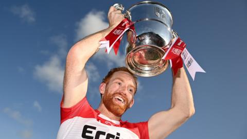 Conor Glass holds the Anglo-Celt Cup aloft at Clones