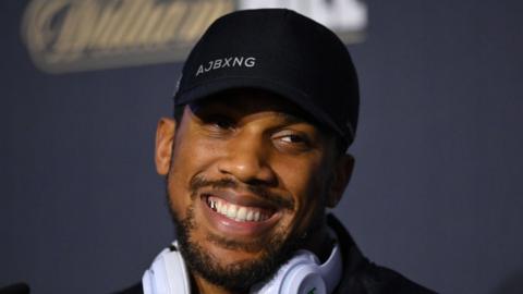 Anthony Joshua smiles during a press conference