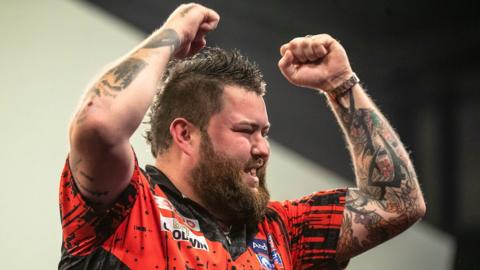 Michael Smith celebrates