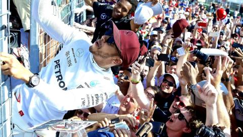 Lewis Hamilton celebrates with fans