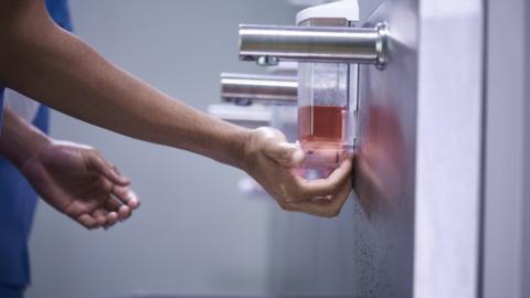 A medic washing their hands in a hospital