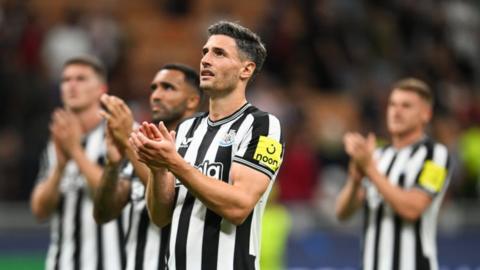 Newcastle players applaud the fans