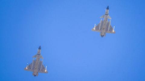 Two J-16 air fighters fly over a training base of PLA's naval aviation force in Ningbo in east China's Zhejiang province