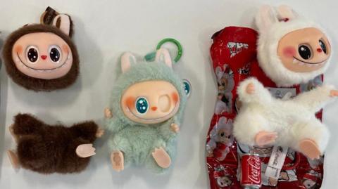 Three fake Labubu dolls - they all either have missing eyes or the head has come away from the body.