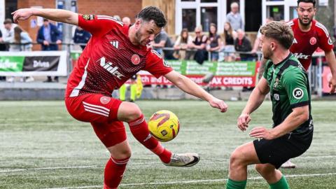 Newtown's Aaron Williams (left) in action against Aberystwyth Town