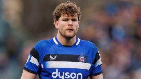 Ethan Staddon standing on the pitch during a match wearing Bath kit
