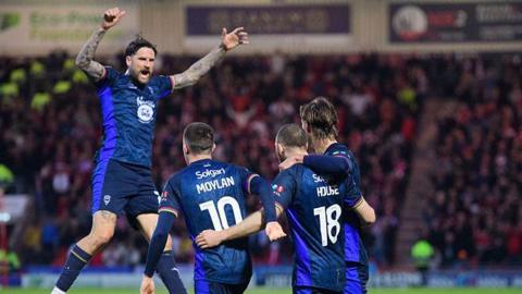 Lincoln City players celebrating a goal at Doncaster