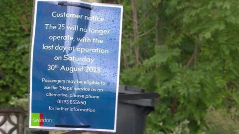A laminated sign tied to a post with cable ties. It has a blue background with white text, It says 'Customer notice - the 25 will no longer operate, with the last day of operation on Saturday 30th August 2025. Passengers may be eligible to use the 'steps' service as an alternative, please phone 01793 855550 for further information'
