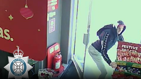 A grainy CCTV image of David Mundy stealing an entire chocolate stand from a shop.