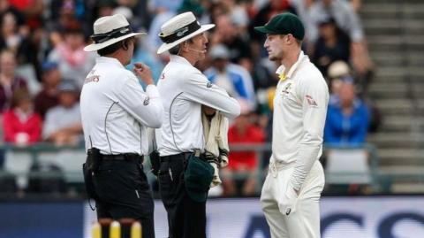 Cameron Bancroft speaks to umpires after being spotted with sandpaper