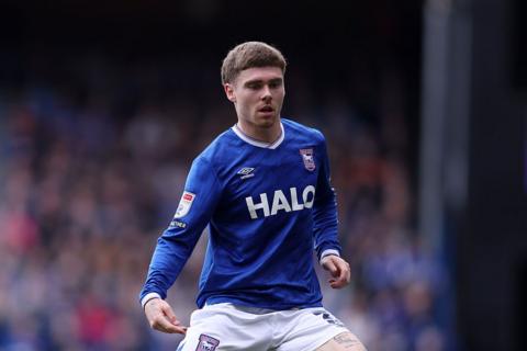 Leif Davis, wearing blue and white Ipswich Town strip, in action during a match.