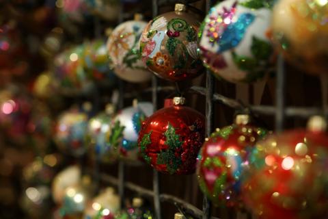 Rows of colourful and sparkly baubles hanging on wires.
