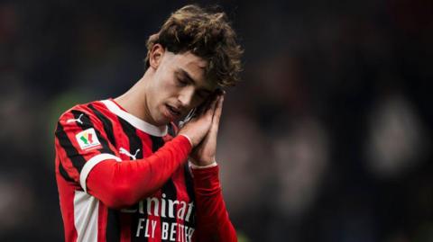 AC Milan's Portuguese forward Joao Felix celebrates scoring a goal in Serie A by raising his hands to the side of his head and pretending to sleep.