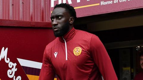 Bevis Mugabi walks out of the tunnel and onto the pitch