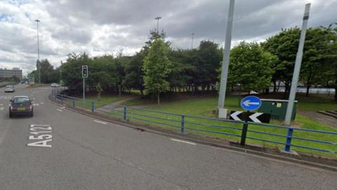 A generic image of Dartmouth Circus, showing cars on the left and trees and grass on the roundabout