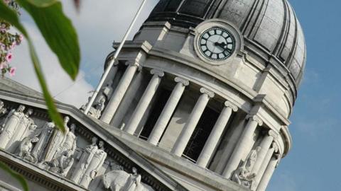 A close up image of the clock on the top of Nottingham's Council House building in the city centre