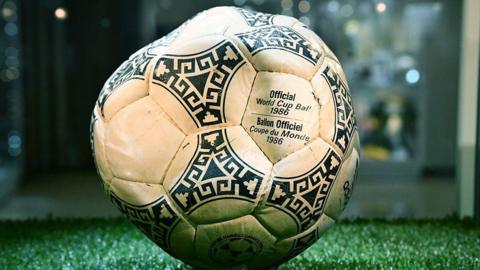 A black and white football with Official World Cup Ball 1986 written on it.