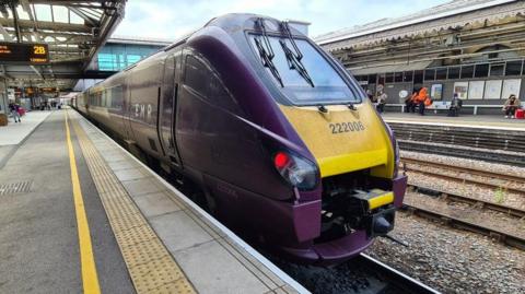 An East Midlands Railway train stopped at a Sheffield station.