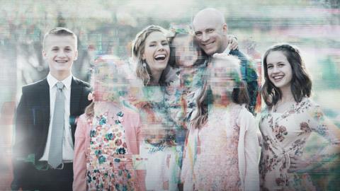A group portrait of six people outdoors, partially obscured by heavy digital glitches, pixelation and scan lines. Several faces are blurred or distorted, creating a corrupted, unsettling effect against an otherwise bright family-style photograph.