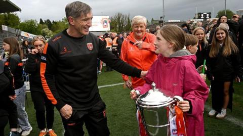 Kieran McGeeney with his daughter Leah and the Anglo-Celt Cup