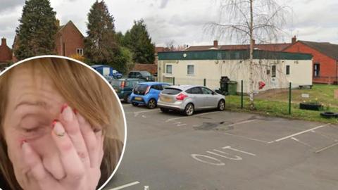 Councillor Milly Boylan, with her face in her hand, looking tired, pictured next to the single-storey, white shelter building.