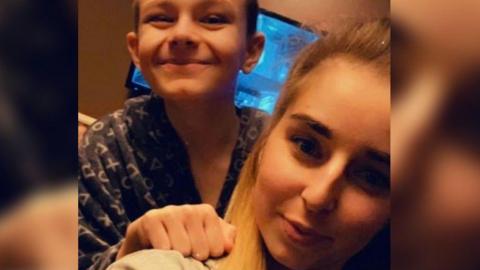 Chloe Rist with her brother Mason taking a selfie type of picture. They are both smiling at the camera. Chloe has blonde hair and Mason brown. 