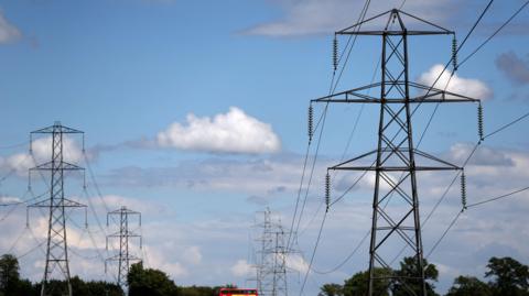 Electricity pylons are seen in London, Britain August 1, 2017. There are some clouds in the sky- with a mainly blue sky.