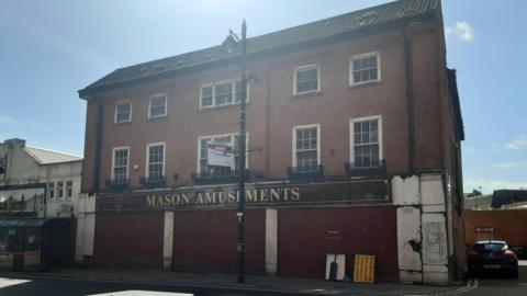 A general view of the former Mason Amusements building in Holmeside, Sunderland, with a 'sold' sign and closed shutters