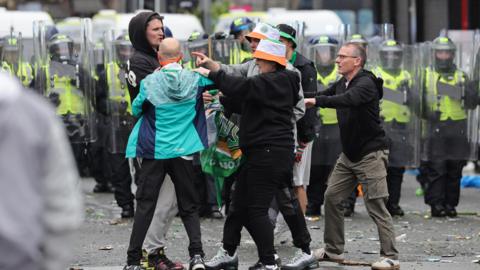Celtic fans clash as they celebrate in Glasgow after their side won the William Hill Premiership title after a 3-1 win at home to Hearts