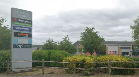 Street view of the Stukeley Road Retail Park. It shows a sign with the other businesses - including a Range, Halfords, Carpetright and Tapi - but The Food Warehouse is not yet listed.