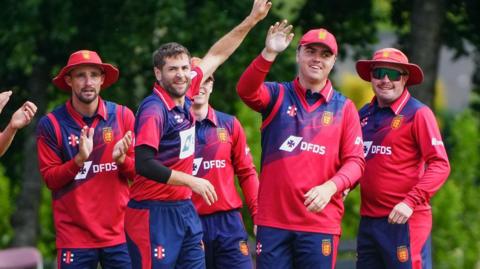Jersey platers celebrate taking a Scottish wicket