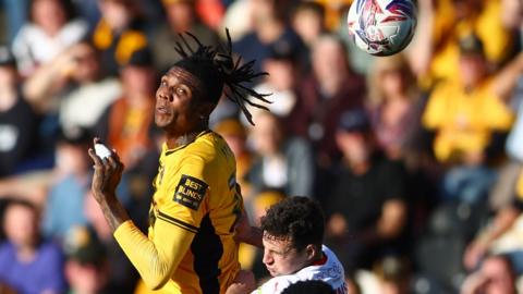 Newport County's Kyle Hudlin towers over the Fleetwood defense