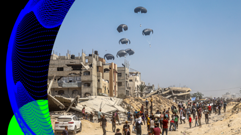 A photo showing a airdrop operation. Aid attached to parachutes falls to the ground with people awaiting below