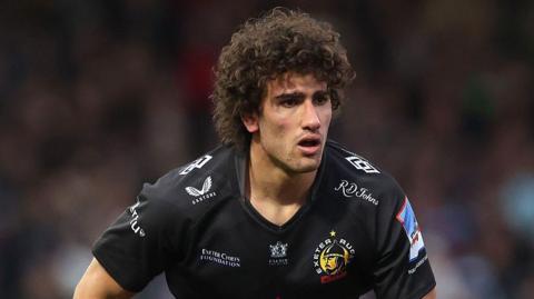 Andrea Zambonin torso and head shot looking forward, focused, wearing black Exeter Chiefs home kit